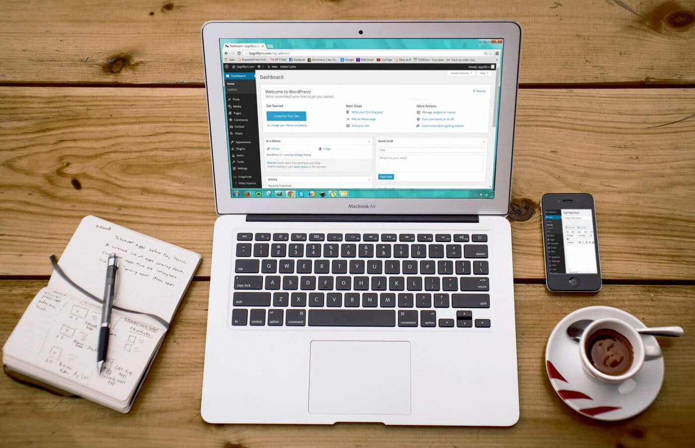 A blogger writing at a laptop with a coffee, working from a bright home desk