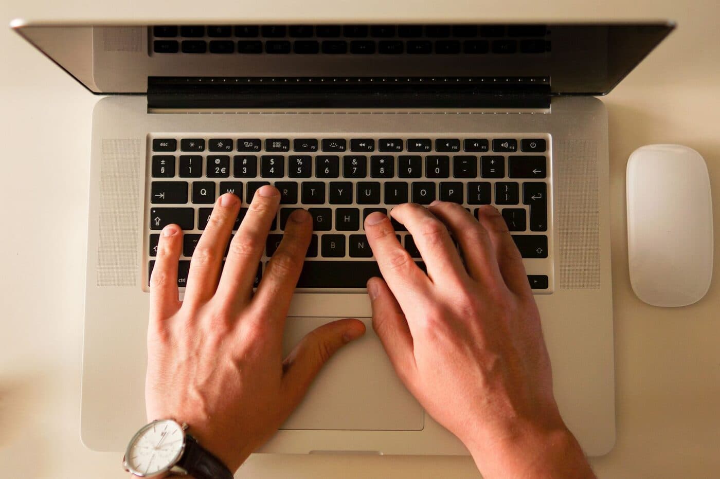 A professional blogger writing at a tidy desk with a laptop and notebook